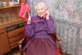 Happy senior woman using retro style landline phone at home Royalty Free Stock Photo