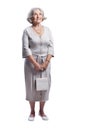 Happy senior woman wearing light dress posing on white background Royalty Free Stock Photo