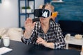 Happy senior woman wearing virtual reality headset
