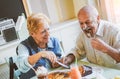 Happy seniors couple eating pancakes in a bar restaurant - Mature people having fun dining together at home Royalty Free Stock Photo