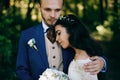 Happy sensual Bride and groom at wedding Day embracing with love. Romantic young couple celebrating their marriage in forest Royalty Free Stock Photo