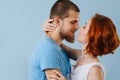 Happy couple in love kissing at home over blue background. Royalty Free Stock Photo