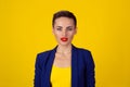 Happy serious young beautiful happy business woman looking at you isolated yellow background. Closeup confident lawyer teacher Royalty Free Stock Photo