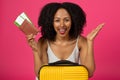 Happy shocked cute young african american curly woman with open mouth hold passport, tickets