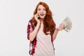 Happy Shocked ginger woman in shirt talking by smartphone