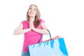 Happy shopaholic with colorful shopping bags praying Royalty Free Stock Photo