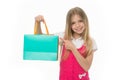 Happy shopaholic girl. Child buy modern items on sale. Girl smiling happy face pointing shopping bag, isolated white