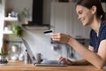 Happy shopper girl using laptop and credit card at home, Royalty Free Stock Photo