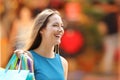 Happy shopper with shopping bags walking