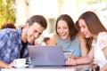 Happy shoppers paying online with credit card in a bar