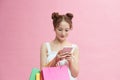 Happy shopping woman texting on her cell phone Royalty Free Stock Photo