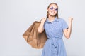 Happy shopping woman with win gesture excited and cheerful in joyful bliss with shopping bags isolated on white background Royalty Free Stock Photo