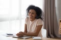 Happy young african woman laughing sitting at home office desk Royalty Free Stock Photo