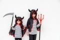 Happy sibling girls at the Halloween party. Children wearing costumes Halloweens. Concept of children ready for a party