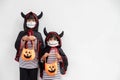 Happy sibling girls at the halloween party. children wearing costumes halloweens. concept of children ready for a party