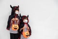 Happy sibling girls at the halloween party. children wearing costumes halloweens. concept of children ready for a party