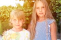 Happy sibling kids travelers boy brother of five years old and girl sister eight years old friends hugging on green plants backgro