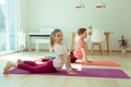 Happy children making yoga at home dueing coronavirus quarantine