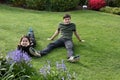 Siblings relaxing in garden Royalty Free Stock Photo