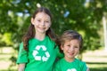 Happy siblings in green smiling at the camera