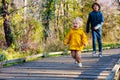 Happy siblings playing catch-up in autumn park Royalty Free Stock Photo