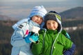 Happy siblings with snow