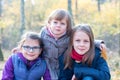 Happy siblings - Three sisters in the autumnal forest smiling Royalty Free Stock Photo