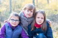 Happy siblings - Three sisters in the autumnal forest smiling Royalty Free Stock Photo