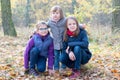 Happy siblings - Three sisters in the autumnal forest smiling Royalty Free Stock Photo