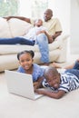 Happy siblings using their laptop Royalty Free Stock Photo