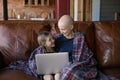 Happy sick mother cancer patient and little daughter using laptop Royalty Free Stock Photo