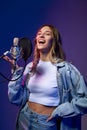 Happy singer girl with microphone.