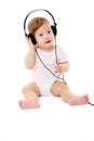 Happy singing baby wearing big black headphones Royalty Free Stock Photo