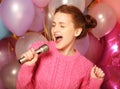 Happy singing girl. Beauty woman with microphone over backgroun Royalty Free Stock Photo