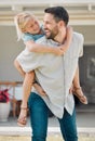 Happy single father giving his little daughter a piggyback ride outside in the garden. Smiling caucasian single parent Royalty Free Stock Photo