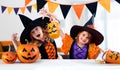 Happy Sisters With Carnival Costumes Indoors - Cheerful Children Play With Pumpkins Royalty Free Stock Photo