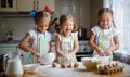 Happy sisters children girls bake cookies, knead dough, play wit Royalty Free Stock Photo