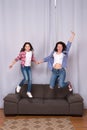 Happy sisters jump in freedom sense. mother and daughter having fun on weekend. move in new house. full of energy. real Royalty Free Stock Photo