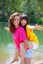 Happy sisters by lake