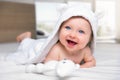 Happy six month old baby lying on a bed Royalty Free Stock Photo