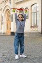 Happy skater girl in headphones raise penny board over head summer street outdoors, fun Royalty Free Stock Photo