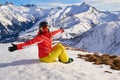 Happy skier girl taking a break above Saint-Jean-d`Arves village, France, in Les Sybelles ski resort. Winter activities