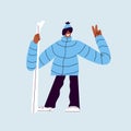 Happy skier with skis. A man in ski goggles and warm clothes is holding skis. Smiling guy in a ski suit posing for a