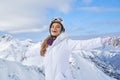 Happy skier woman on the background of snowy mountains