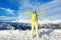 Happy skier woman throwing snow up