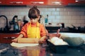 Little Girl Rolls out the Dough with the rolling Pin