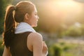 Happy slim woman wearing sportswear in the garden at sunrise. Young beautiful asian female in sports bra running outdoor Royalty Free Stock Photo