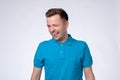 Happy sly man in blue t-shirt winking an eye Royalty Free Stock Photo