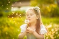 Small girl blowing dandelion Royalty Free Stock Photo