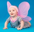 Happy small girl butterfly wings sitting on the floor Royalty Free Stock Photo